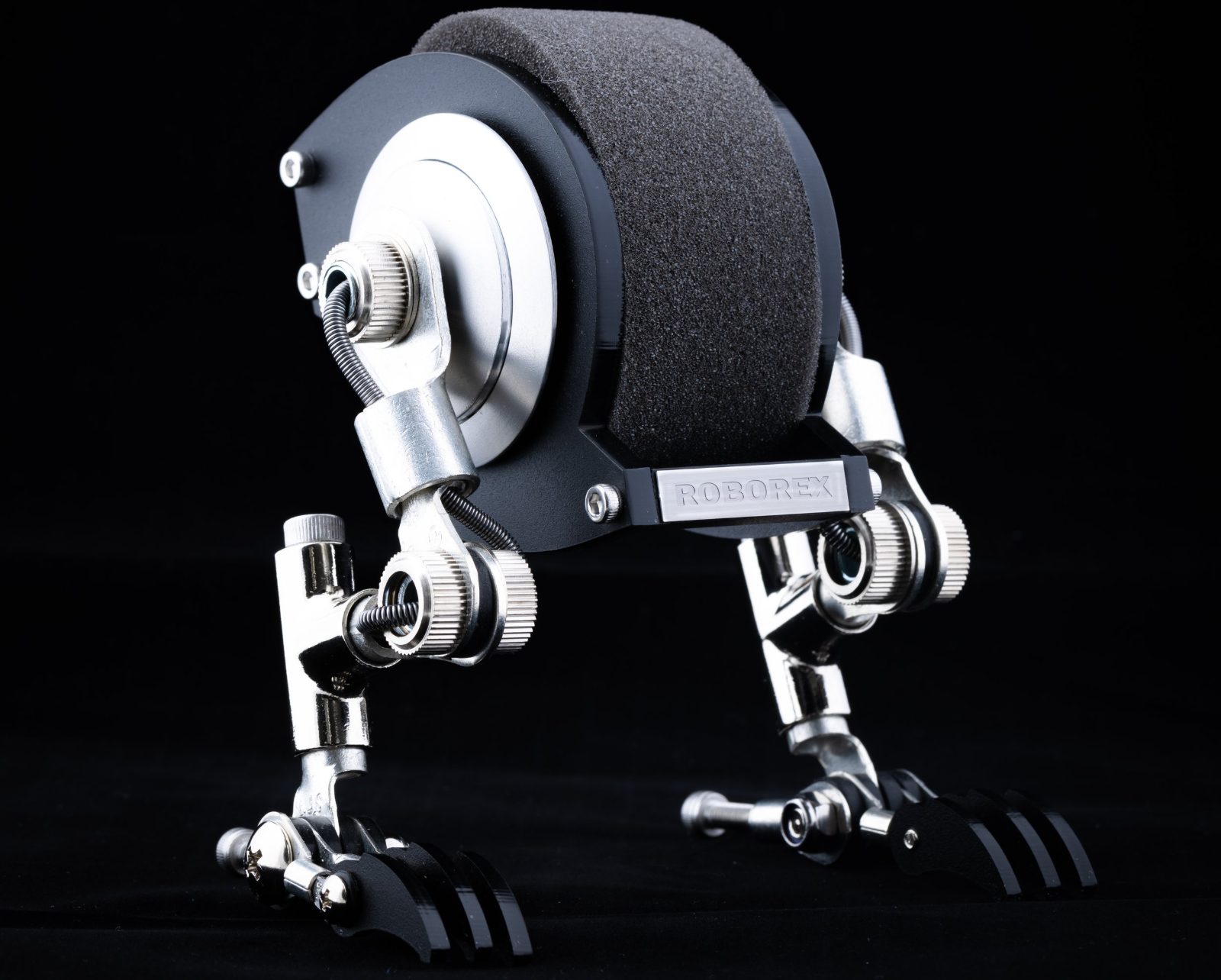 The Roborex watch stand: a chrome and black robot figure with articulated legs and a ROBOREX nameplate